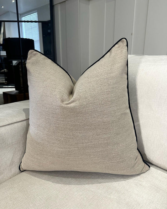 Beige linen like cushion with black piping